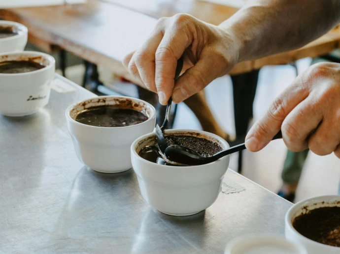 person mixing black coffee